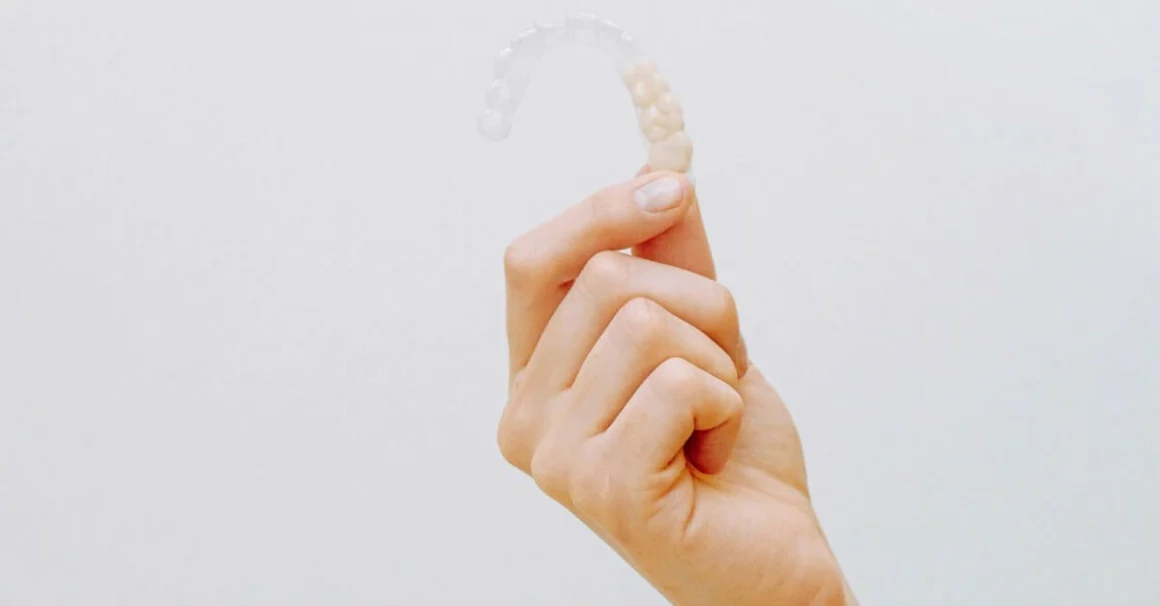 Hand holding dental retainers