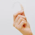 Hand holding dental retainers